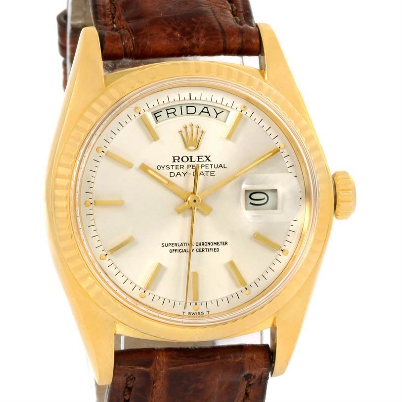 The image shows a frontal view of a Rolex President 1803 Men
s Yellow Gold Silver Dial 1803 Men
s Yellow Gold Silver Dial model watch, displaying the day, date, and leather strap.