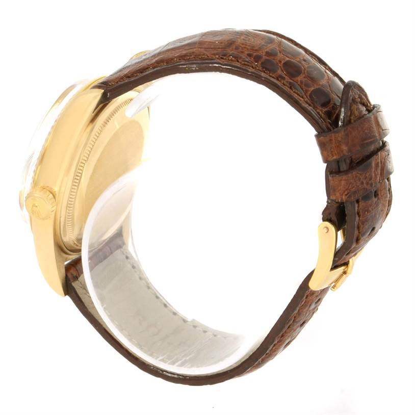 The Rolex President 1803 Men
s Yellow Gold Silver Dial 1803 Men
s Yellow Gold Silver Dial model watch is shown from the side, highlighting the case, crown, and brown leather strap with a gold buckle.