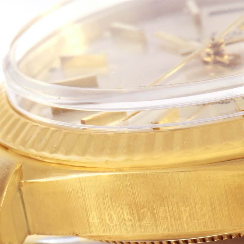 Close-up side view of the Rolex President 1803 Men
s Yellow Gold Silver Dial 1803 Men
s Yellow Gold Silver Dial model showing the edge of the dial, case, and part of the serial number.