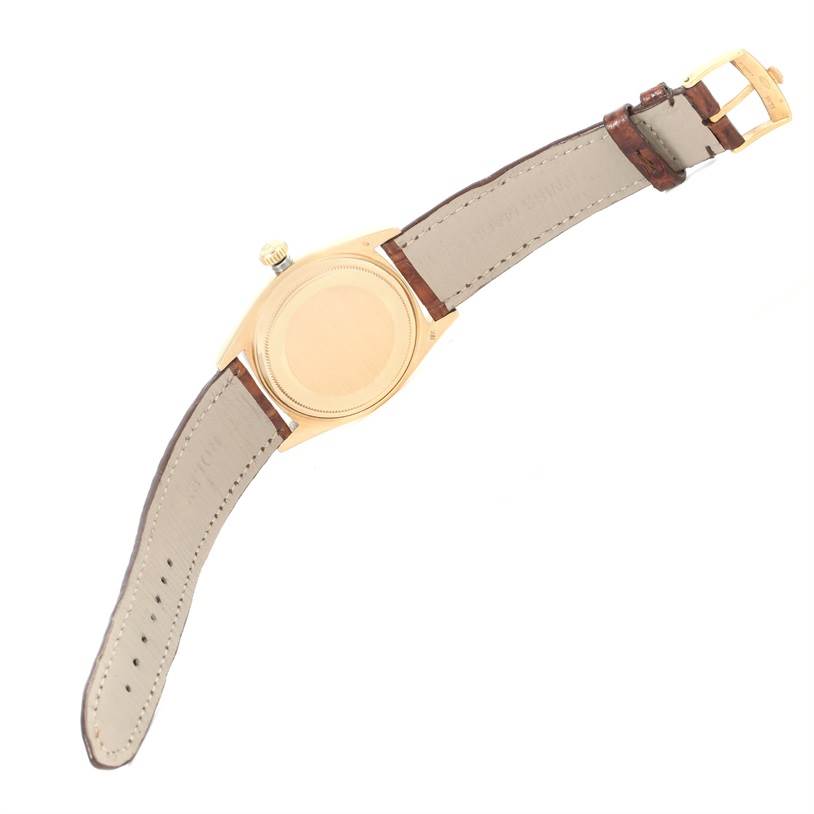 The image shows the back case and strap of a Rolex President 1803 Men
s Yellow Gold Silver Dial 1803 Men
s Yellow Gold Silver Dial model watch, viewed from the backside.