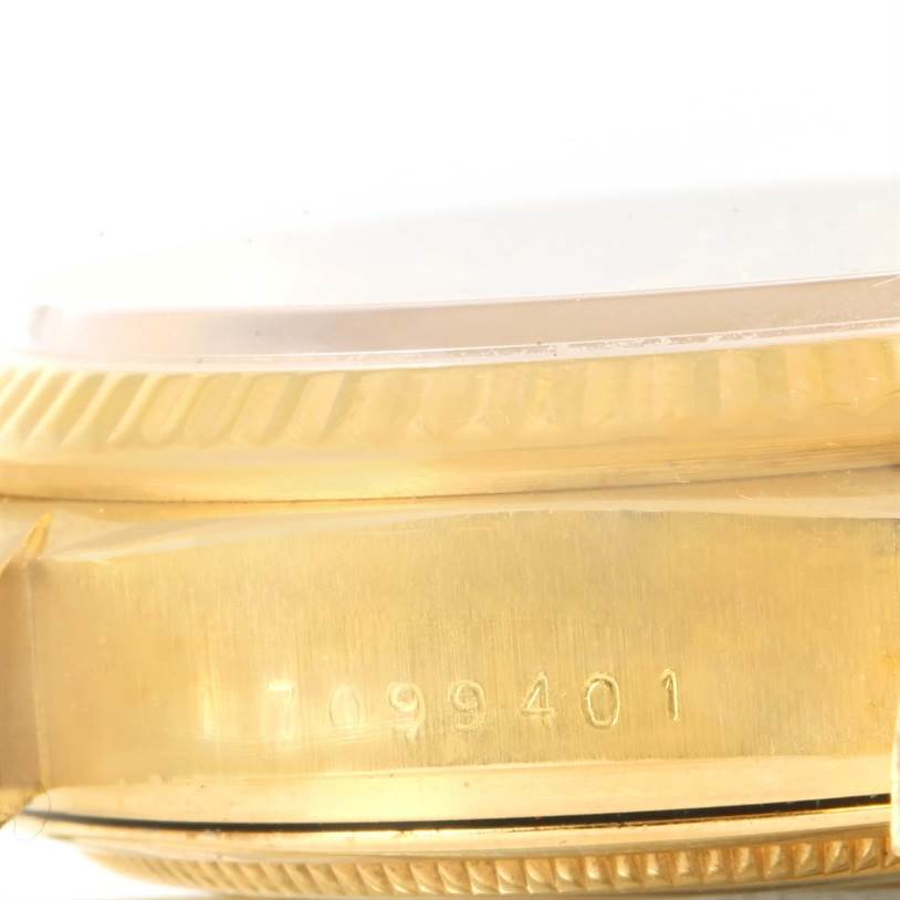 The image shows a close-up side view of the Rolex President 18038 Men
s Yellow Gold Champagne Dial 18038 Men
s Yellow Gold Champagne Dial model, highlighting the engraved serial number and bezel.