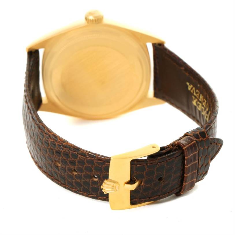 The image shows the back case and leather strap buckle of a Rolex President 1803 Men
s Yellow Gold Silver Dial 1803 Men
s Yellow Gold Silver Dial model watch.