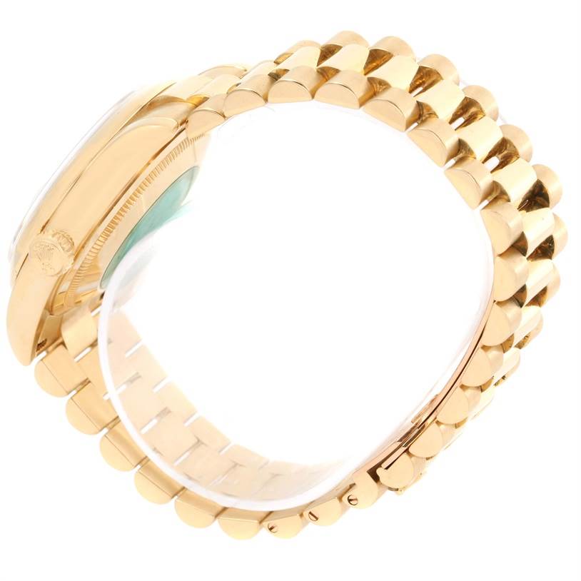 The image shows a side view of the President model by Rolex, highlighting its gold band and watch case.