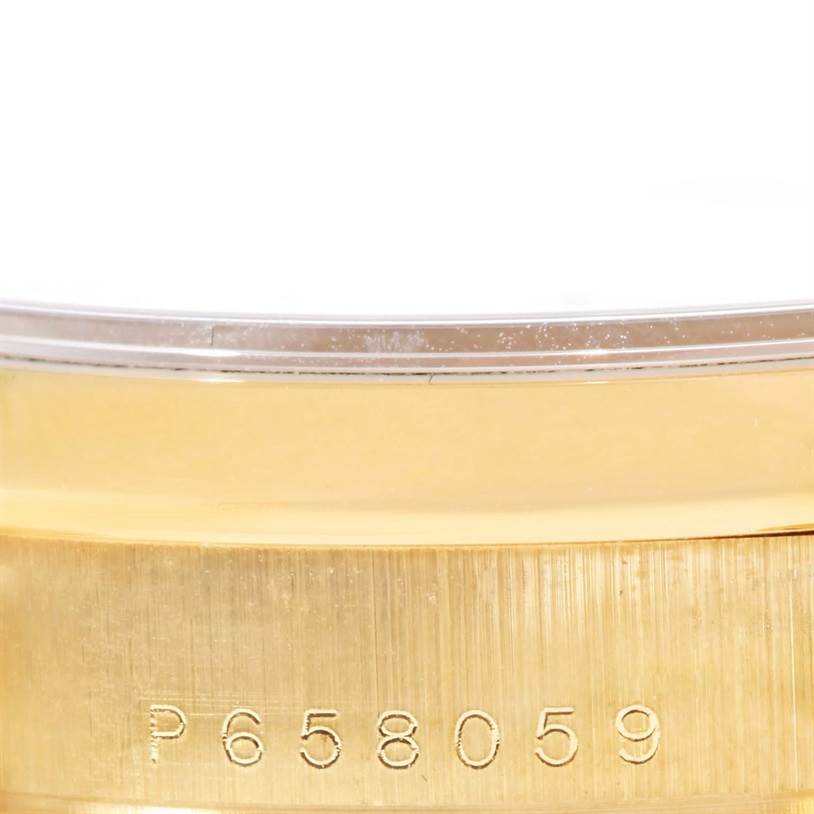 The image shows a close-up of the serial number engraved on the gold case back of a Rolex President 118208 Men
s Yellow Gold White Dial 118208 Men
s Yellow Gold White Dial model watch.