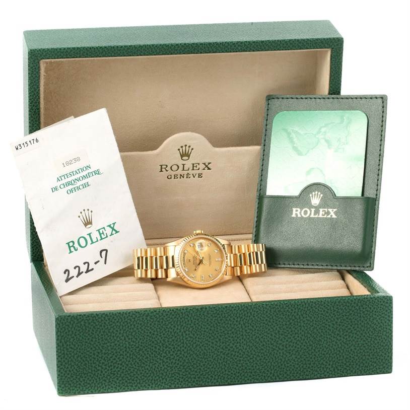 The Rolex President 18238 Men
s Yellow Gold Champagne Dial 18238 Men
s Yellow Gold Champagne Dial model watch is shown in an open display box with certification papers and a green cardholder.
