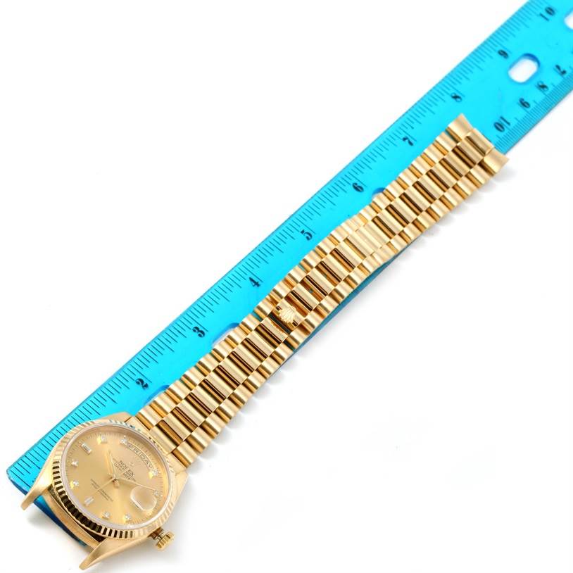 The Rolex President 18238 Men
s Yellow Gold Champagne Dial 18238 Men
s Yellow Gold Champagne Dial watch model is shown from an overhead angle, displaying its face, bracelet, and partially removed crown.