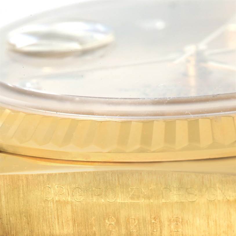 This image shows a close-up side view of the bezel and part of the case of a Rolex President 18238 Men
s Yellow Gold Champagne Dial 18238 Men
s Yellow Gold Champagne Dial model watch.