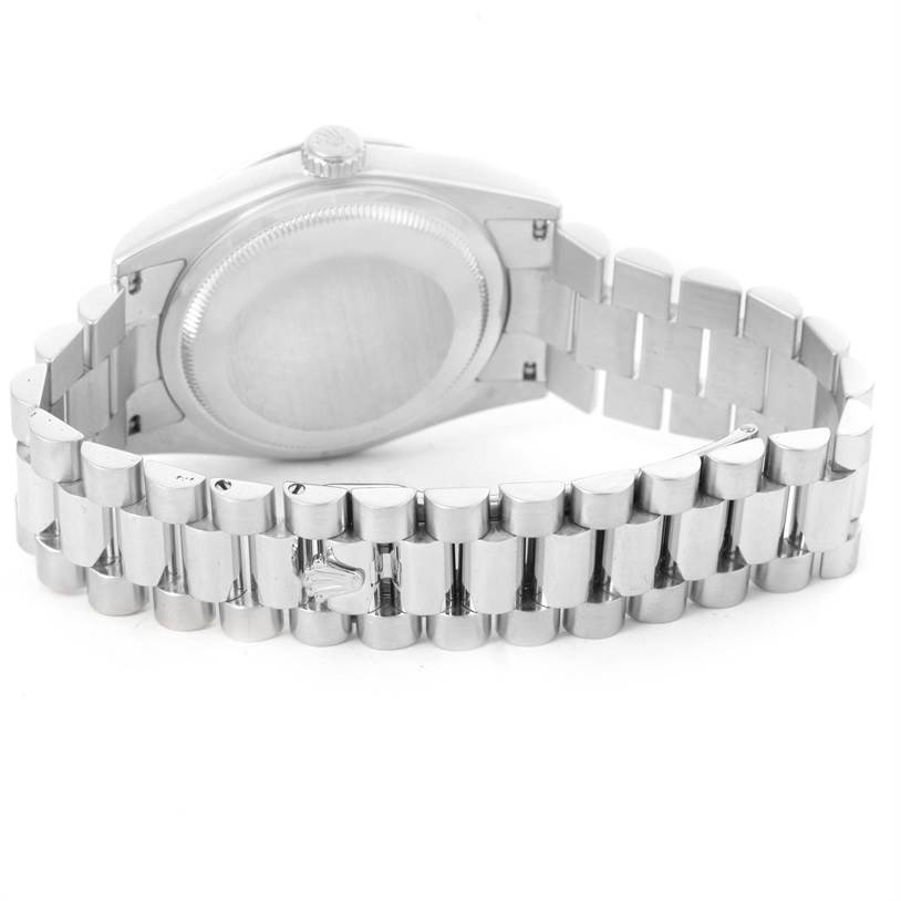 The image shows the back case and part of the bracelet of a Rolex President 118206 Men's Platinum Silver Dial 118206 Men's Platinum Silver Dial model watch.