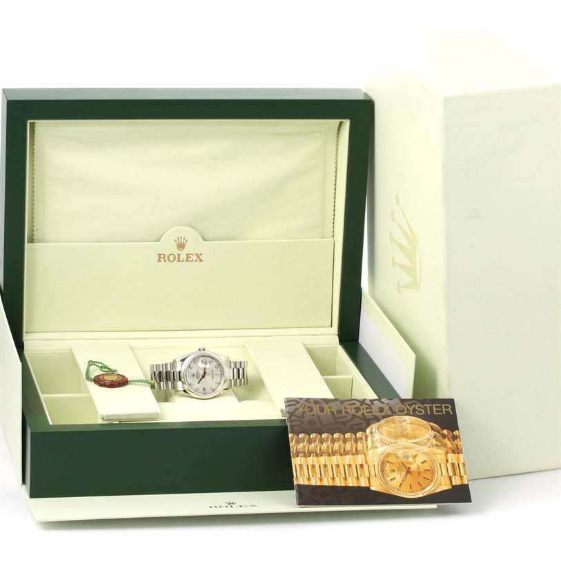 The image shows a Rolex President 118206 Men's Platinum Silver Dial 118206 Men's Platinum Silver Dial model watch in its box with accompanying accessories and documentation viewed from the front.