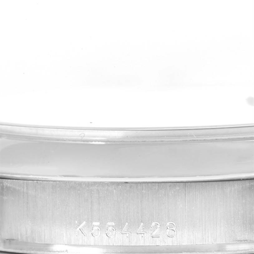 The image shows a close-up of the serial number engraved on the side of the case of a Rolex President 118206 Men's Platinum Silver Dial 118206 Men's Platinum Silver Dial watch.
