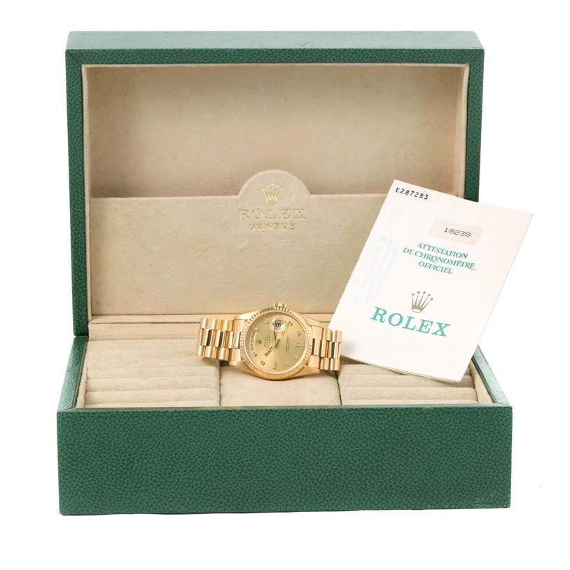 The image shows a Rolex President 18238 Men
s Yellow Gold Champagne Dial 18238 Men
s Yellow Gold Champagne Dial model watch in its box with an official Rolex chronometer certificate.