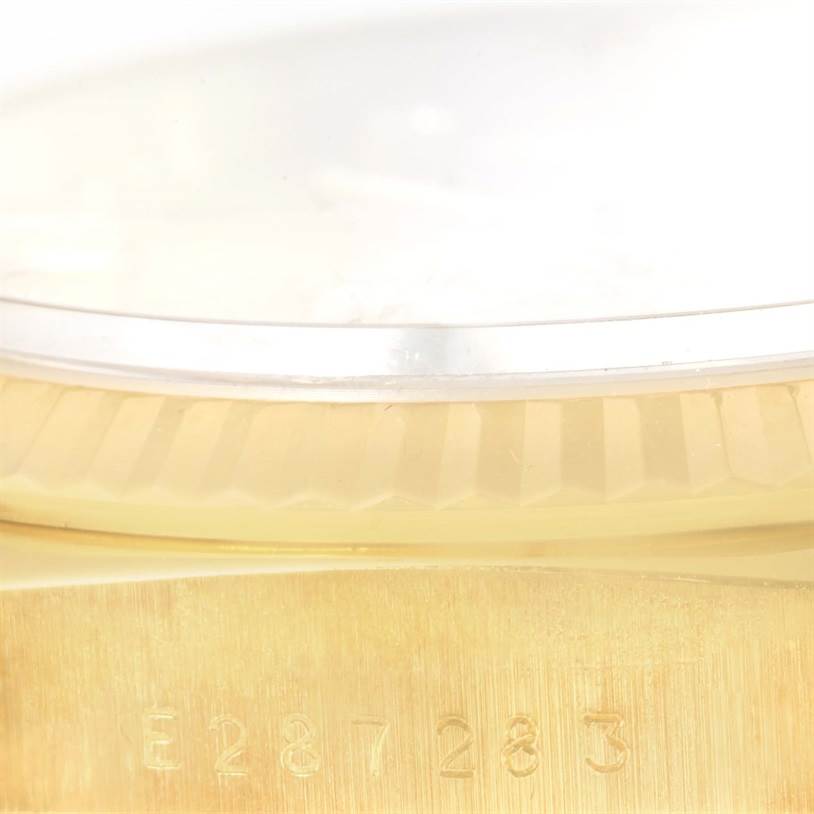 The image shows a close-up of the serial number and fluted bezel on the Rolex President 18238 Men
s Yellow Gold Champagne Dial 18238 Men
s Yellow Gold Champagne Dial model watch.