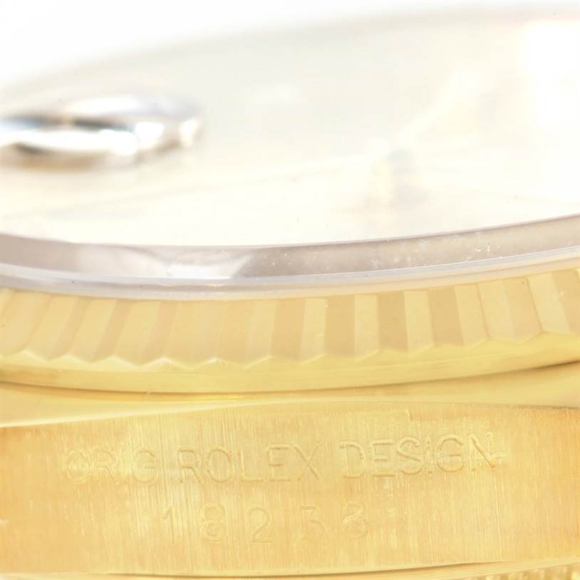 The image shows a close-up of the Rolex President 18238 Men
s Yellow Gold Champagne Dial 18238 Men
s Yellow Gold Champagne Dial model watch, focusing on its gold case and partially visible bezel.
