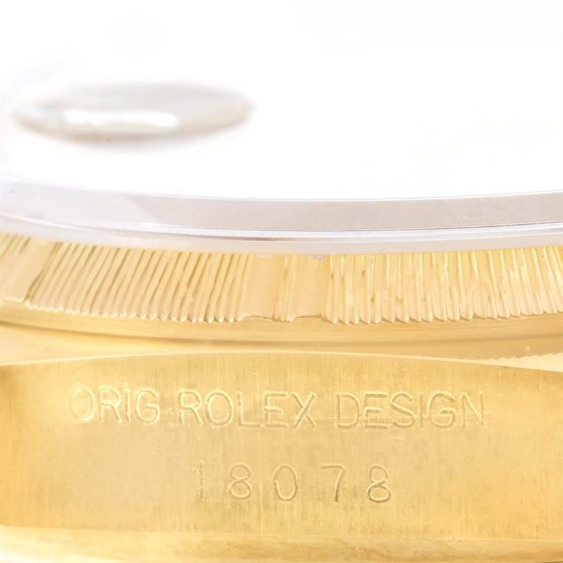 The image shows a close-up of the side of the Rolex President 18078 Men's Yellow Gold Brown Dial 18078 Men's Yellow Gold Brown Dial watch model, featuring the case and bezel with engraved text.