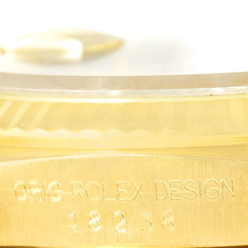 This close-up image shows the side view of a Rolex President 18238 Men
s Yellow Gold Champagne Dial 18238 Men
s Yellow Gold Champagne Dial model watch, highlighting the engraved text "ORIG ROLEX DESIGN 18238."