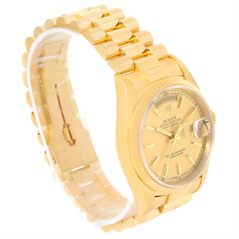 The image shows a side angle of a Rolex President 18238 Men
s Yellow Gold Champagne Dial 18238 Men
s Yellow Gold Champagne Dial model watch, featuring its gold bracelet, crown, and face displaying the day and date.