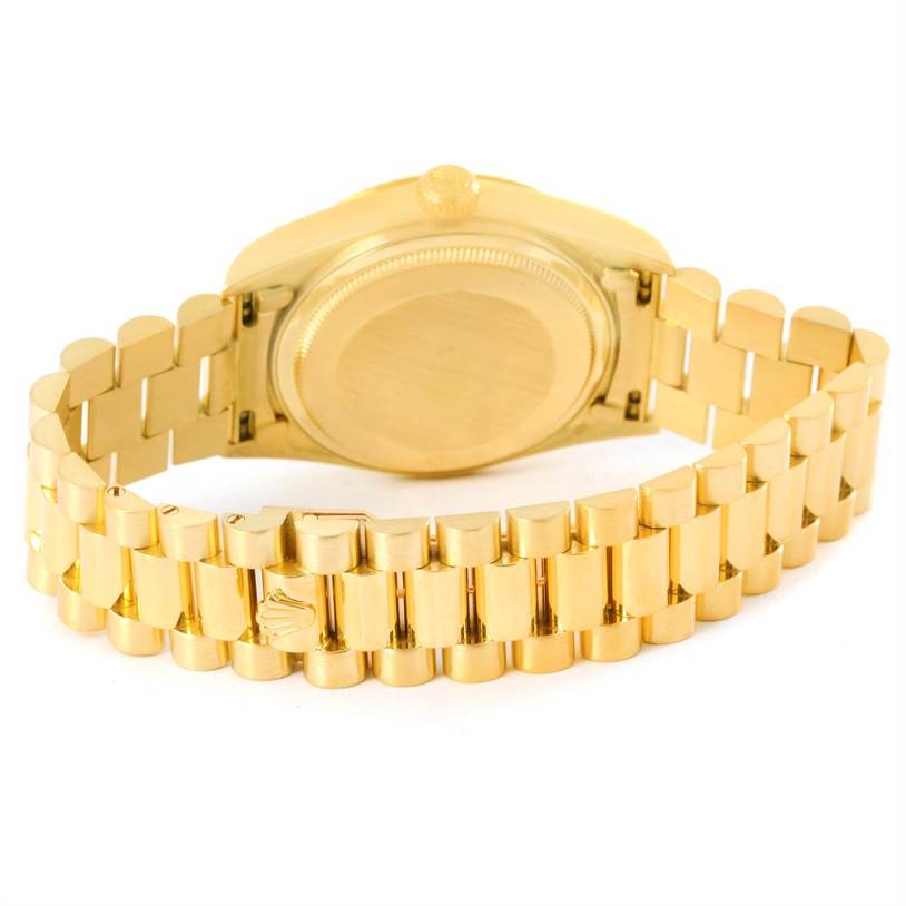 The image shows the back view of a Rolex President 18038 Men
s Yellow Gold Champagne Dial 18038 Men
s Yellow Gold Champagne Dial model watch, featuring its caseback and gold bracelet.