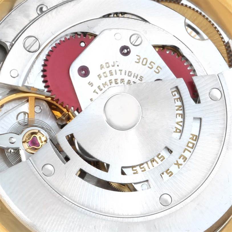 This close-up image shows the intricate inner mechanism of the Rolex President 18038 Men
s Yellow Gold Champagne Dial 18038 Men
s Yellow Gold Champagne Dial model watch, including gears and engravings.