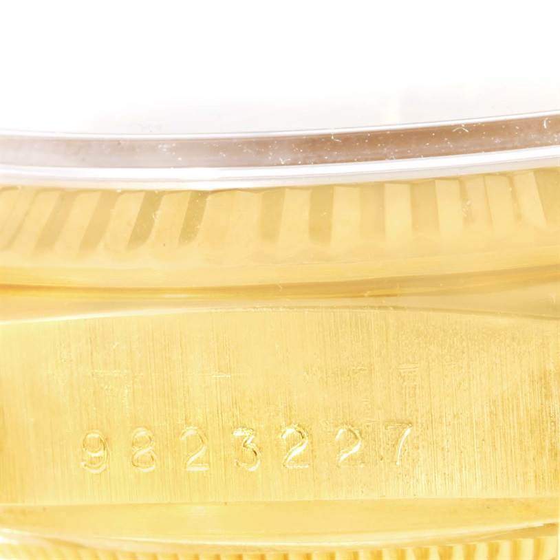 The image shows a close-up angle of the Rolex President 18038 Men
s Yellow Gold Champagne Dial 18038 Men
s Yellow Gold Champagne Dial model
s serial number engraved on its gold case.