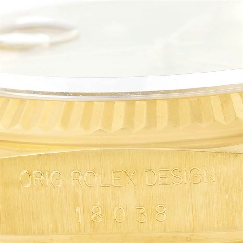 This image shows a close-up of the side of a Rolex President 18038 Men
s Yellow Gold Champagne Dial 18038 Men
s Yellow Gold Champagne Dial model watch, highlighting the "Orig Rolex Design" and model number engraved.