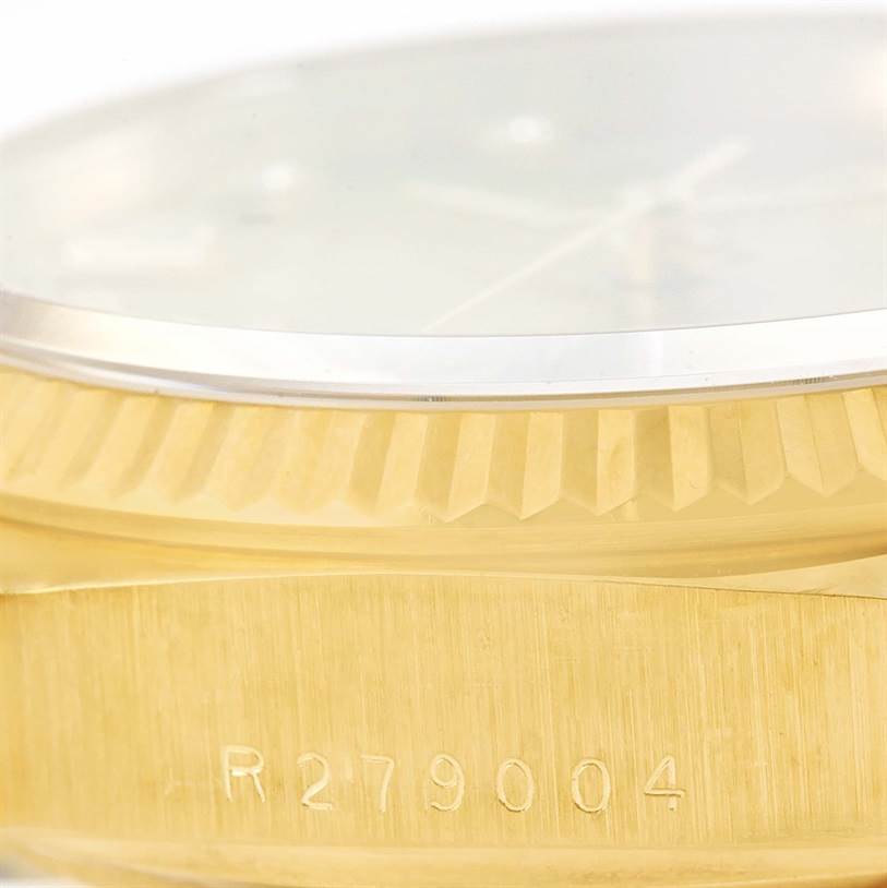 The image shows a close-up side view of the Rolex President 18038 Men
s Yellow Gold Champagne Dial 18038 Men
s Yellow Gold Champagne Dial model watch, highlighting its bezel and engraved serial number.