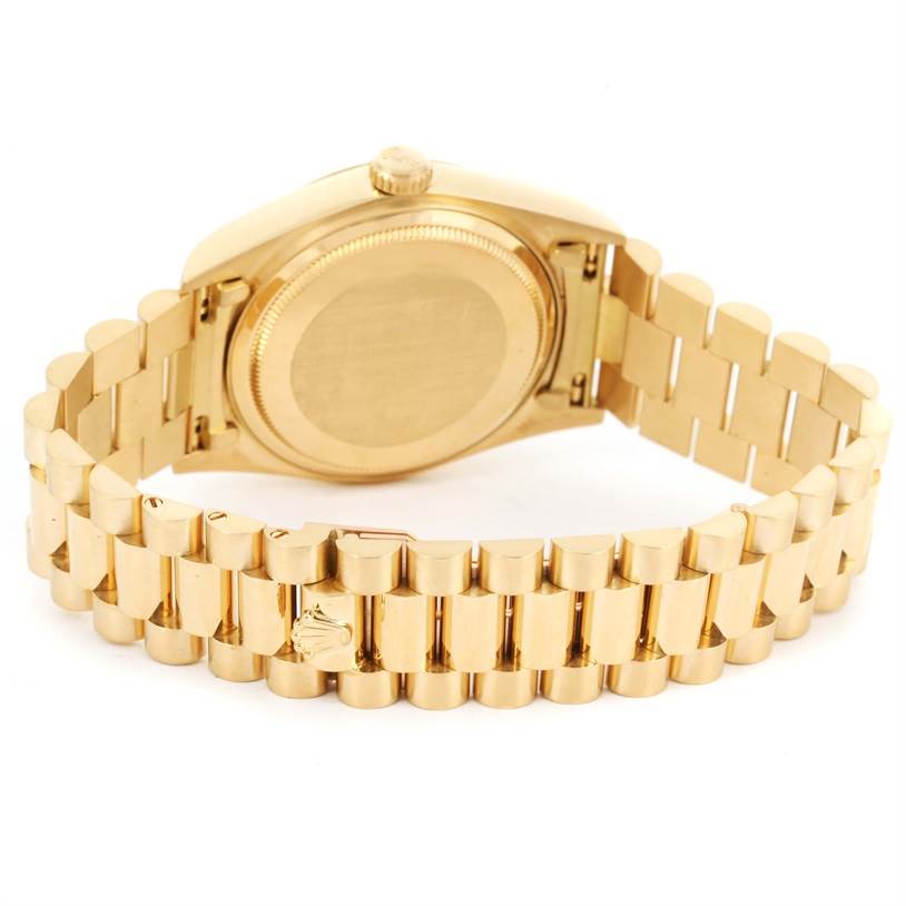 The image shows the back and bracelet of a Rolex President 18038 Men
s Yellow Gold Champagne Dial 18038 Men
s Yellow Gold Champagne Dial model watch, with a focus on its gold case and clasp.