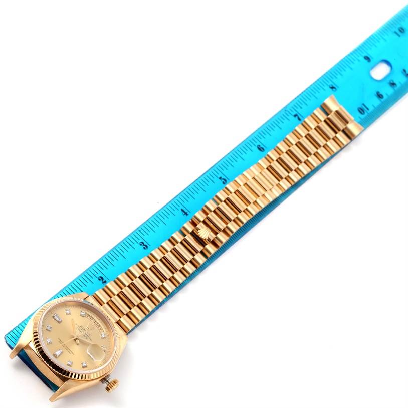 The image shows a Rolex President 18038 Men
s Yellow Gold Champagne Dial 18038 Men
s Yellow Gold Champagne Dial model watch, including its face, band, and a standard ruler for scale.