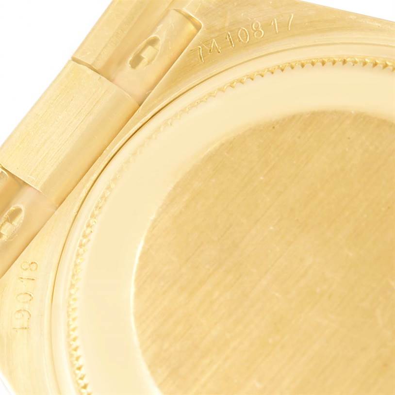 This image shows a close-up of the back cover and part of the bracelet of a Rolex President 19018 Men's Yellow Gold Brown Dial 19018 Men's Yellow Gold Brown Dial model watch.