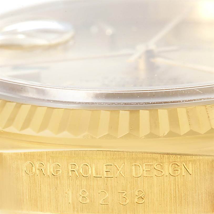 Close-up of a Rolex President 18238 Men
s Yellow Gold Champagne Dial 18238 Men
s Yellow Gold Champagne Dial watch showing the fluted bezel and engraved model number "18238."
