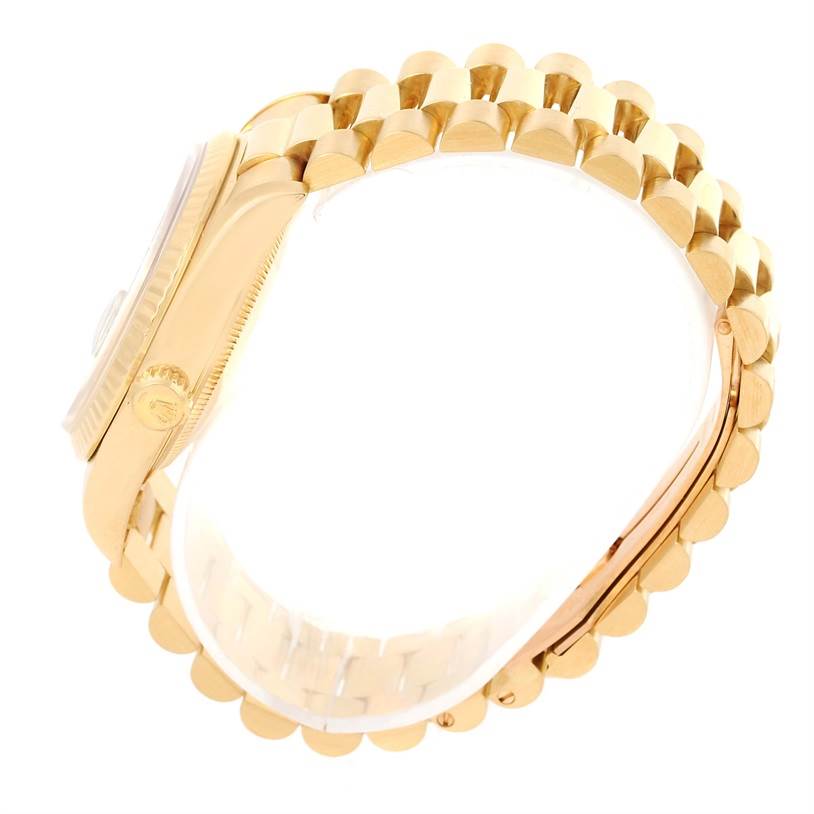 The image shows a side angle of a Rolex President 18238 Men
s Yellow Gold Champagne Dial 18238 Men
s Yellow Gold Champagne Dial watch, focusing on the gold case, bezel, and bracelet.