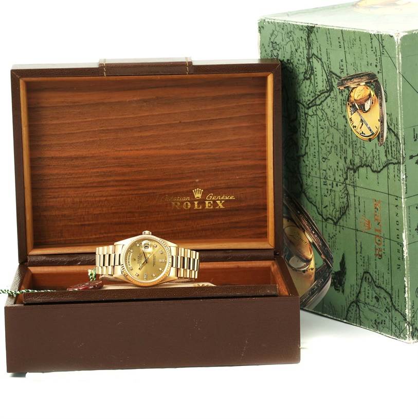 The Rolex President 18238 Men
s Yellow Gold Champagne Dial 18238 Men
s Yellow Gold Champagne Dial model watch is shown from a front angle, inside its open wooden box with a green map-themed outer box visible.