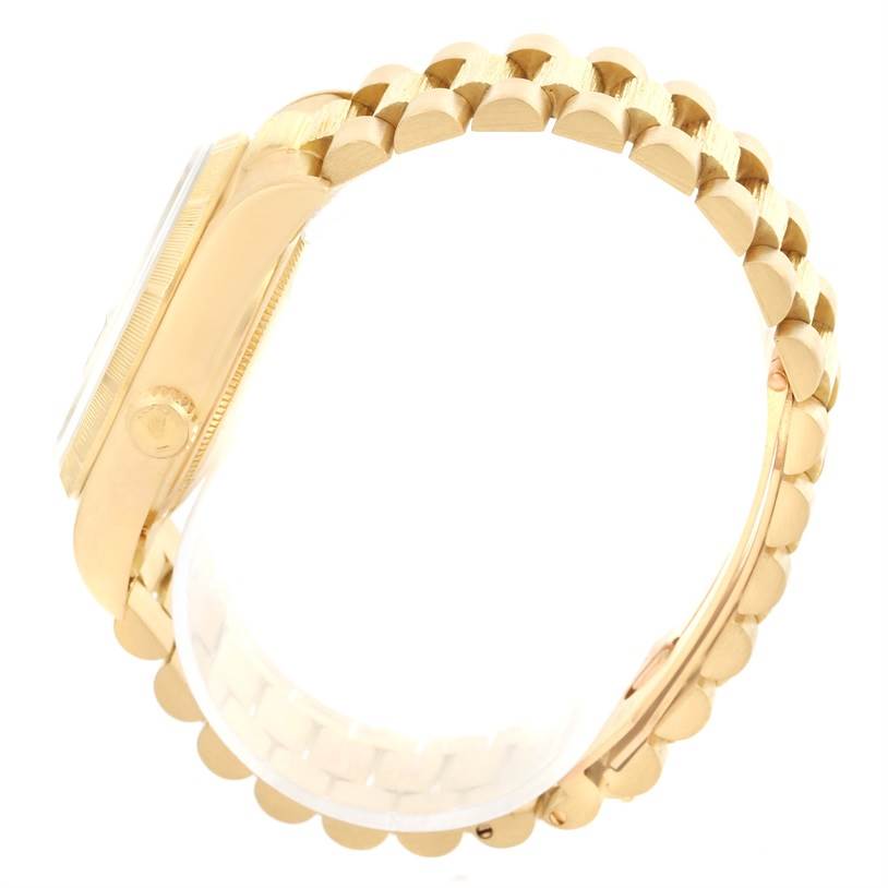 This image shows a side view of the Rolex President 18078 Men
s Yellow Gold Champagne Dial 18078 Men
s Yellow Gold Champagne Dial model watch, displaying the crown and part of the bracelet.