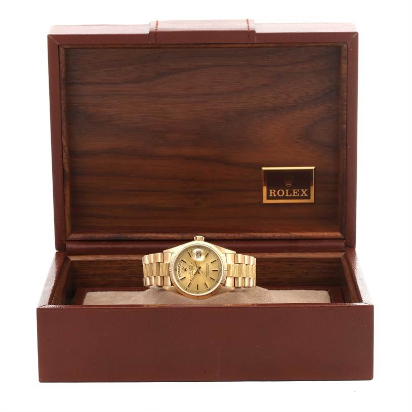 The Rolex President 18078 Men
s Yellow Gold Champagne Dial 18078 Men
s Yellow Gold Champagne Dial watch is shown in its opened wooden box, featuring its gold bracelet and face.