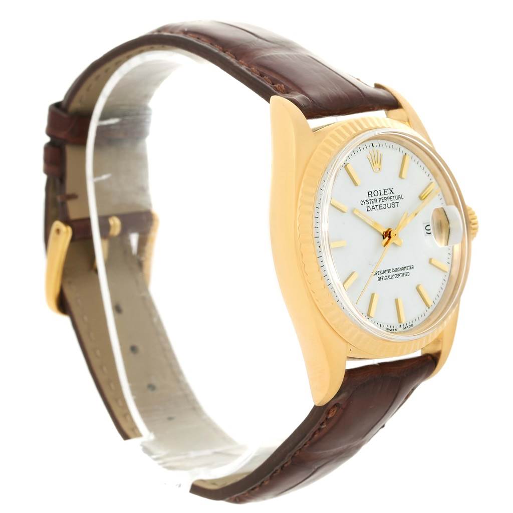 The image shows a side angle of a Rolex President 1601 Men
s Yellow Gold White Dial 1601 Men
s Yellow Gold White Dial model watch, displaying the case, dial, crown, and leather strap.