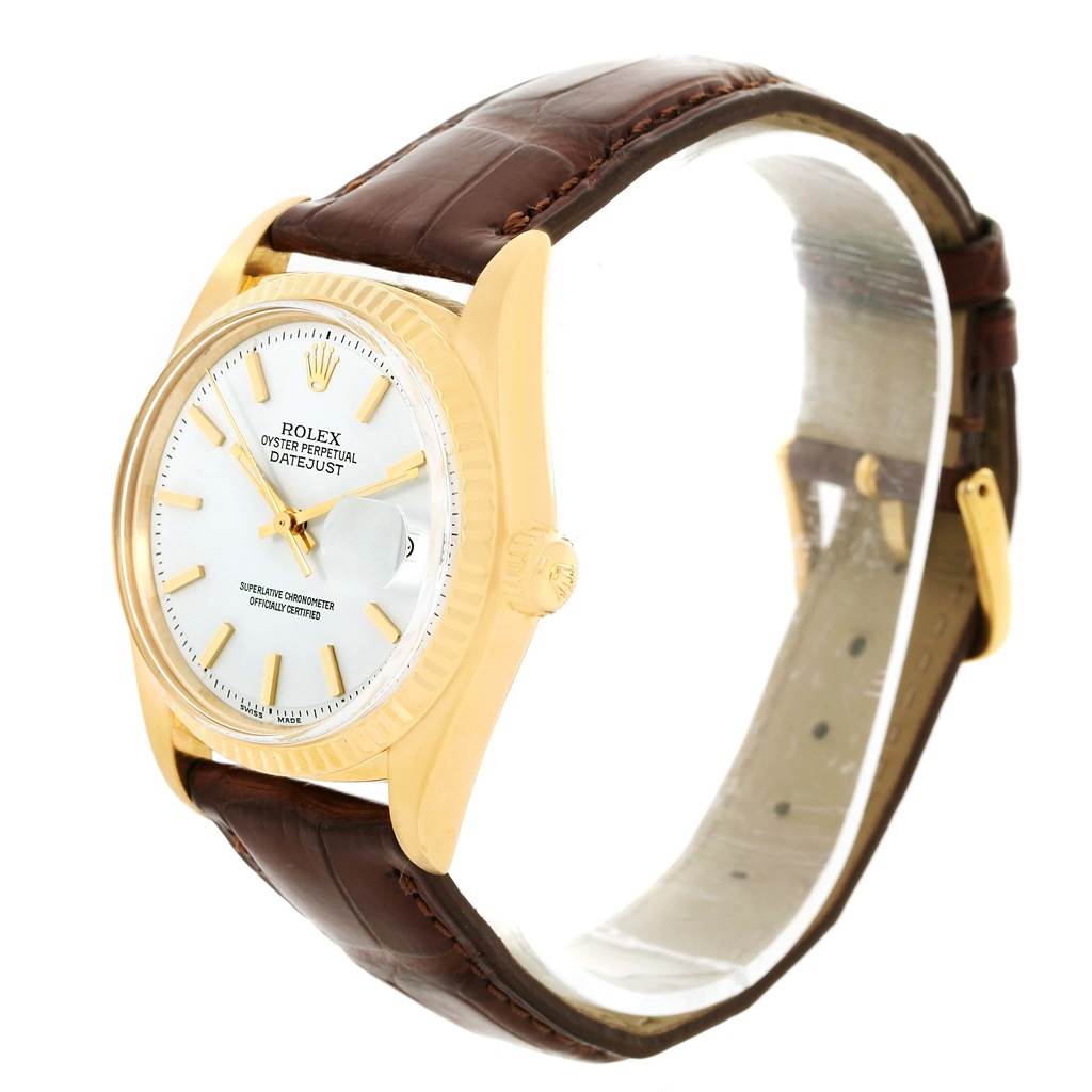 The Rolex President 1601 Men
s Yellow Gold White Dial 1601 Men
s Yellow Gold White Dial model watch has a gold case, white dial, brown leather strap, and is shown at an angle from the left side.