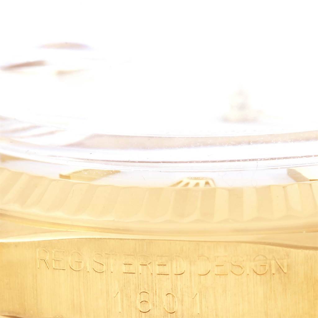 This close-up angle shows the edge of the Rolex President 1601 Men
s Yellow Gold White Dial 1601 Men
s Yellow Gold White Dial model watch, highlighting its bezel and partially visible serial number.