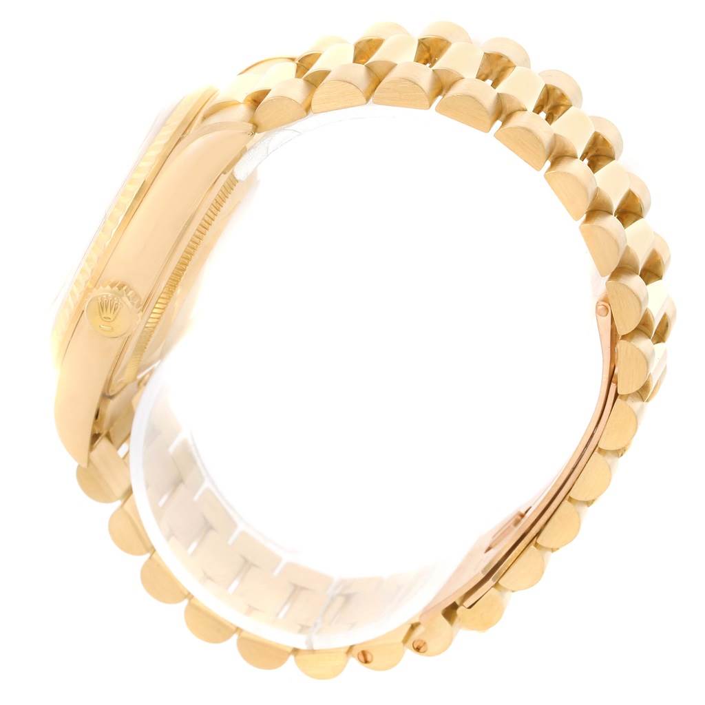 The side-angle view of the Rolex President 18238 Men
s Yellow Gold Champagne Dial 18238 Men
s Yellow Gold Champagne Dial model watch shows its gold case, crown, and bracelet links.