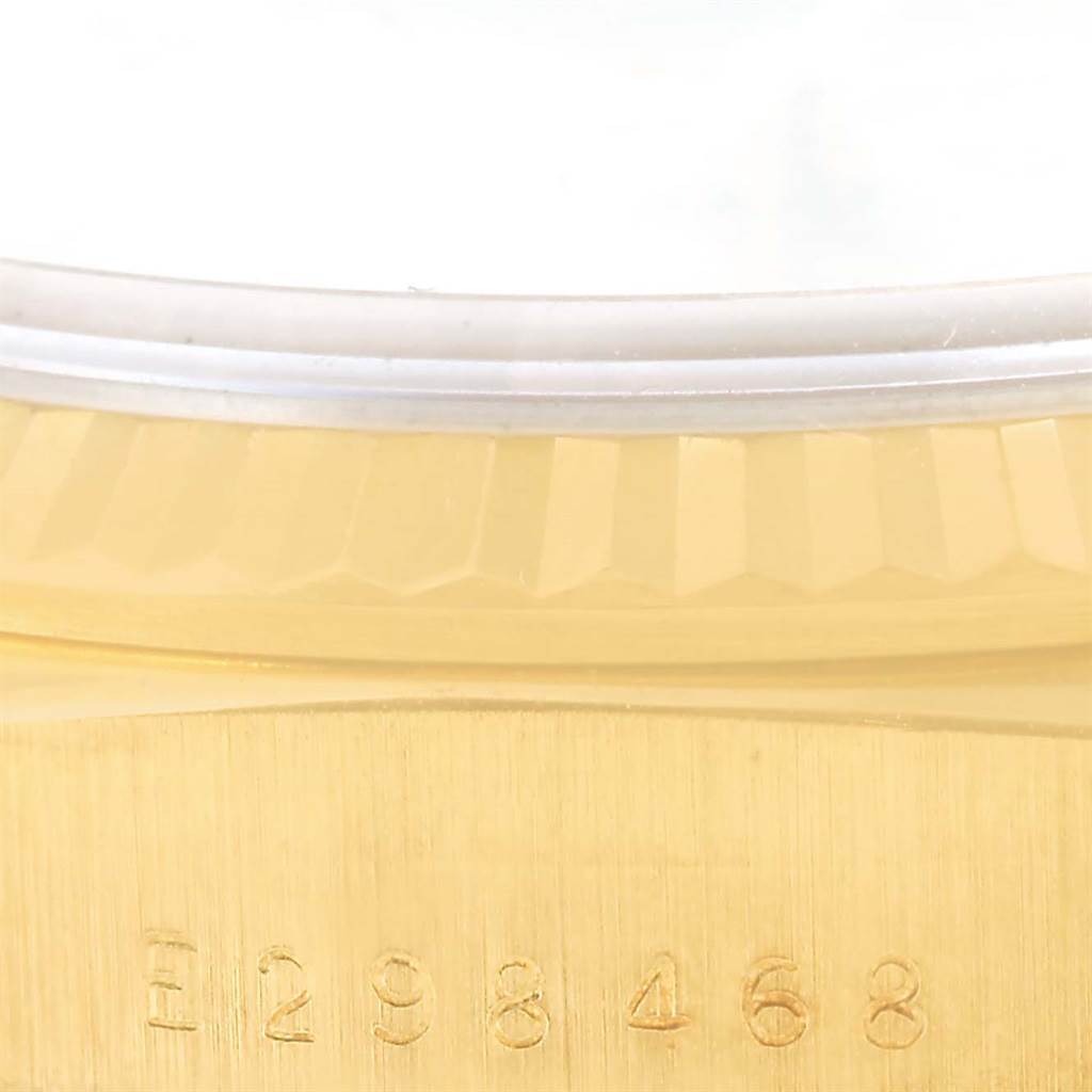 The image shows a partial view of the case and bezel with serial number of a Rolex President 18238 Men
s Yellow Gold Champagne Dial 18238 Men
s Yellow Gold Champagne Dial model watch.