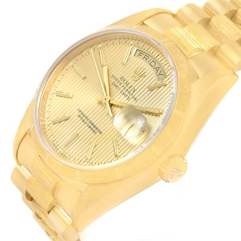 The Rolex President 18078 Men
s Yellow Gold Champagne Dial 18078 Men
s Yellow Gold Champagne Dial model watch is shown at an angle that displays its gold dial, day-date window, crown, and bracelet.