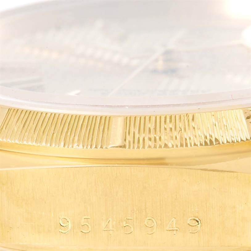 The close-up image shows the side view of a Rolex President 18078 Men
s Yellow Gold Champagne Dial 18078 Men
s Yellow Gold Champagne Dial watch, highlighting the fluted bezel and serial number on the gold case.