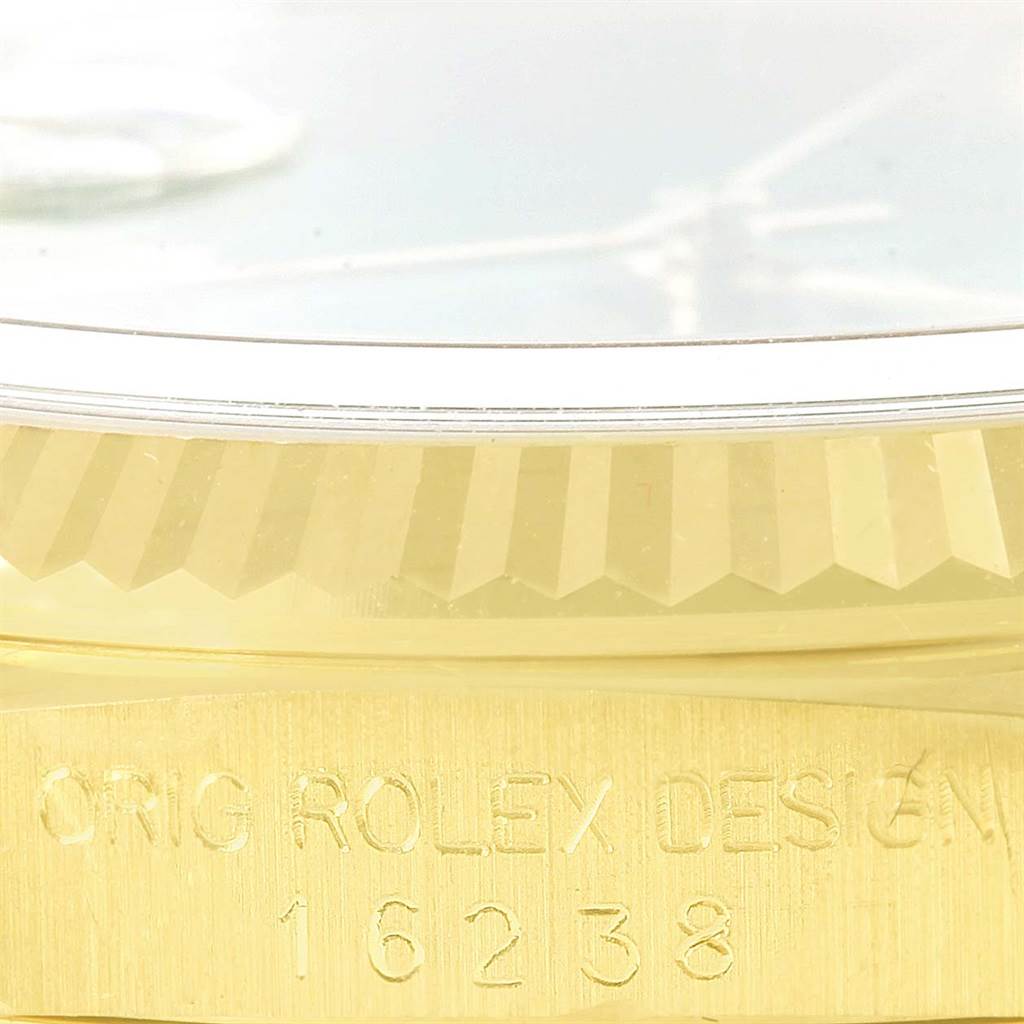 The image shows a close-up of the side view of a Rolex President 16238 Men's Yellow Gold Green Dial 16238 Men's Yellow Gold Green Dial model with visible markings and a fluted bezel.