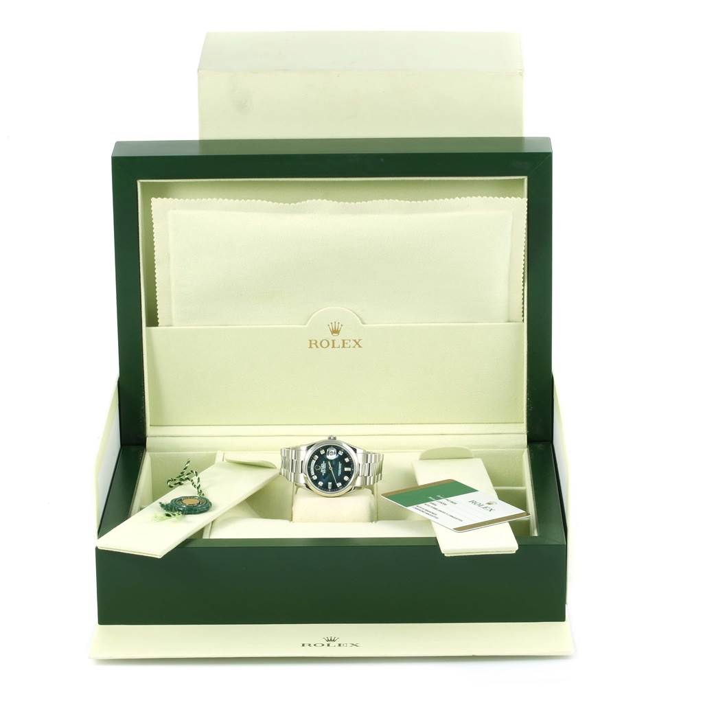 The image shows a Rolex President 118206 Men's Platinum Silver Dial 118206 Men's Platinum Silver Dial model watch placed inside its open green and beige box, along with a tag and documentation.