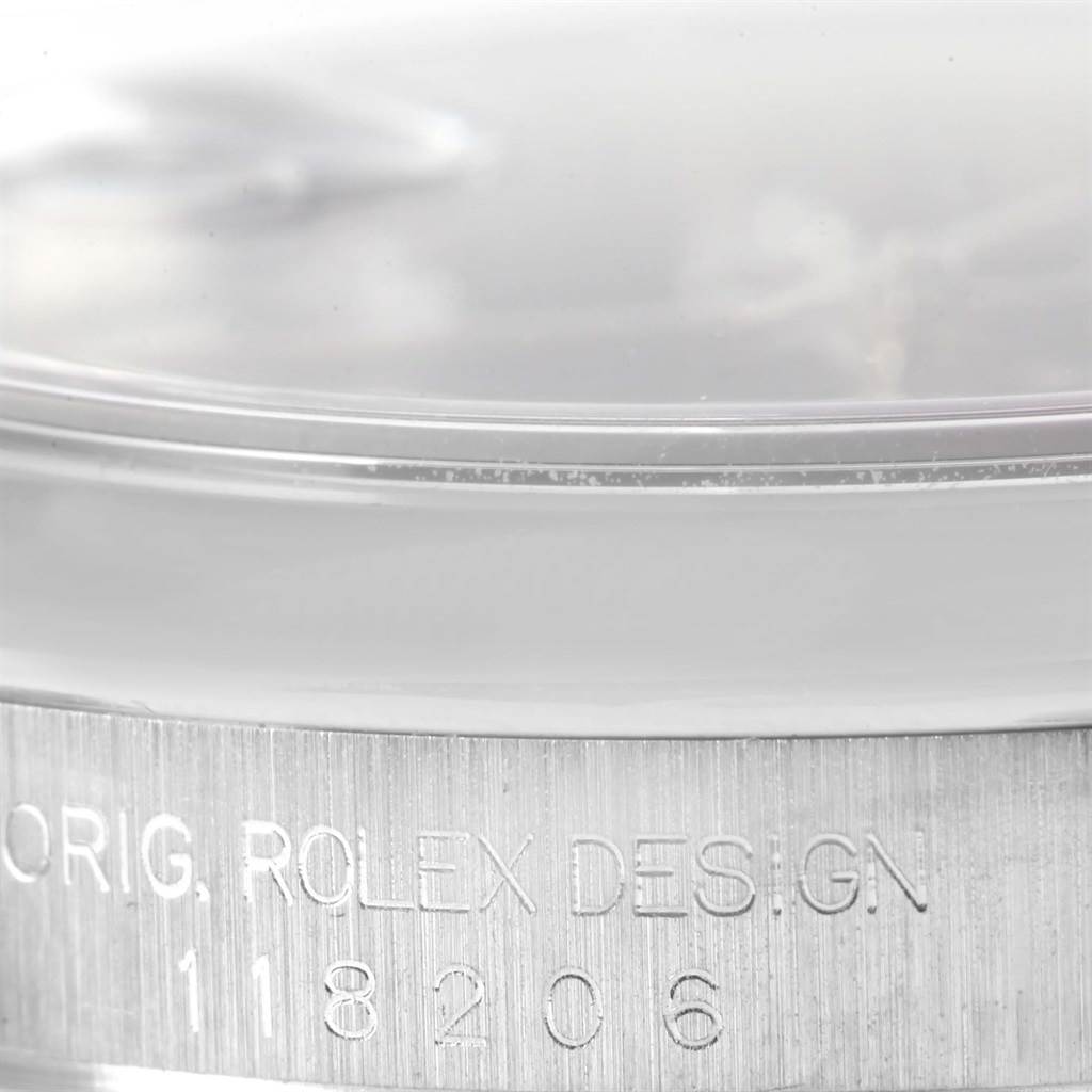 This close-up image shows the engraved side of the case of a Rolex President 118206 Men's Platinum Silver Dial 118206 Men's Platinum Silver Dial model watch, highlighting the brand and design details.