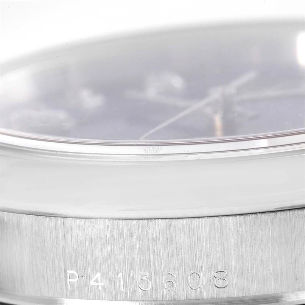 This image shows a close-up of the case side and crystal of a Rolex President 118206 Men's Platinum Silver Dial 118206 Men's Platinum Silver Dial model watch with a serial number visible.
