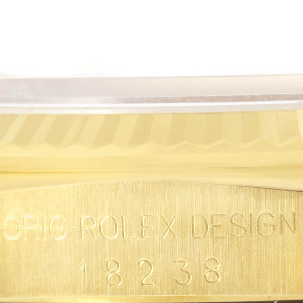 This image shows a close-up of the serial number and 
Orig Rolex Design
 engraving on a Rolex President 18238 Men
s Yellow Gold Champagne Dial 18238 Men
s Yellow Gold Champagne Dial model watch.