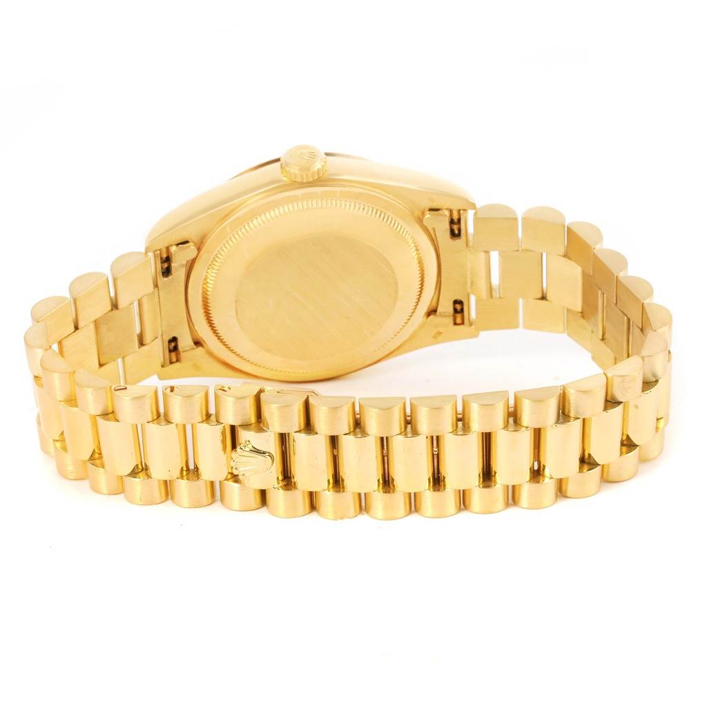 The image shows the back of the Rolex President 18238 Men
s Yellow Gold Champagne Dial 18238 Men
s Yellow Gold Champagne Dial model watch, highlighting the case back and the bracelet.