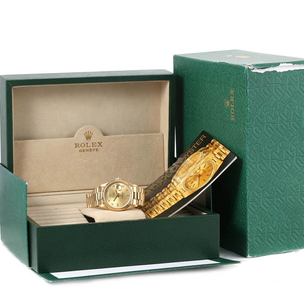 The image shows a Rolex President 18238 Men
s Yellow Gold Champagne Dial 18238 Men
s Yellow Gold Champagne Dial model watch in its open green box, with the watch and informational booklet visible.