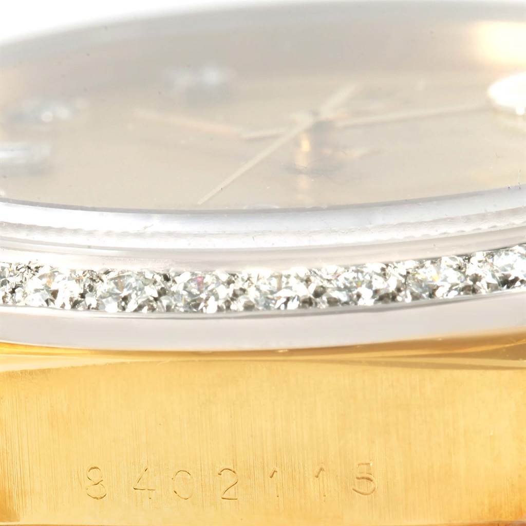 The image shows a close-up view of the bezel with diamonds and a partial side of the case, including the serial number, on a Rolex President 18048 Men
s Yellow Gold Champagne Dial 18048 Men
s Yellow Gold Champagne Dial watch.
