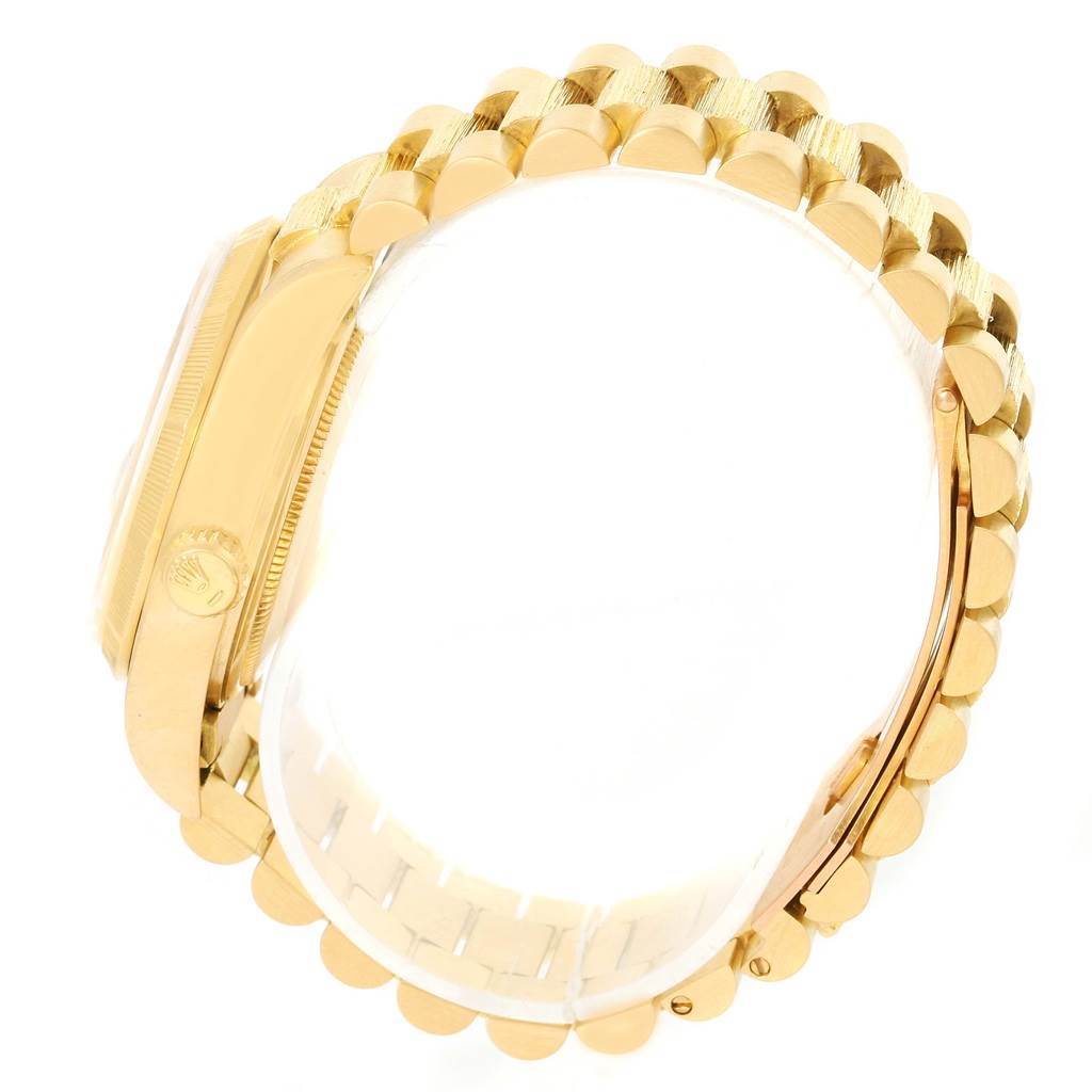 The image shows a side angle of the Rolex President 18078 Men
s Yellow Gold Champagne Dial 18078 Men
s Yellow Gold Champagne Dial model, highlighting its gold wristband and crown.