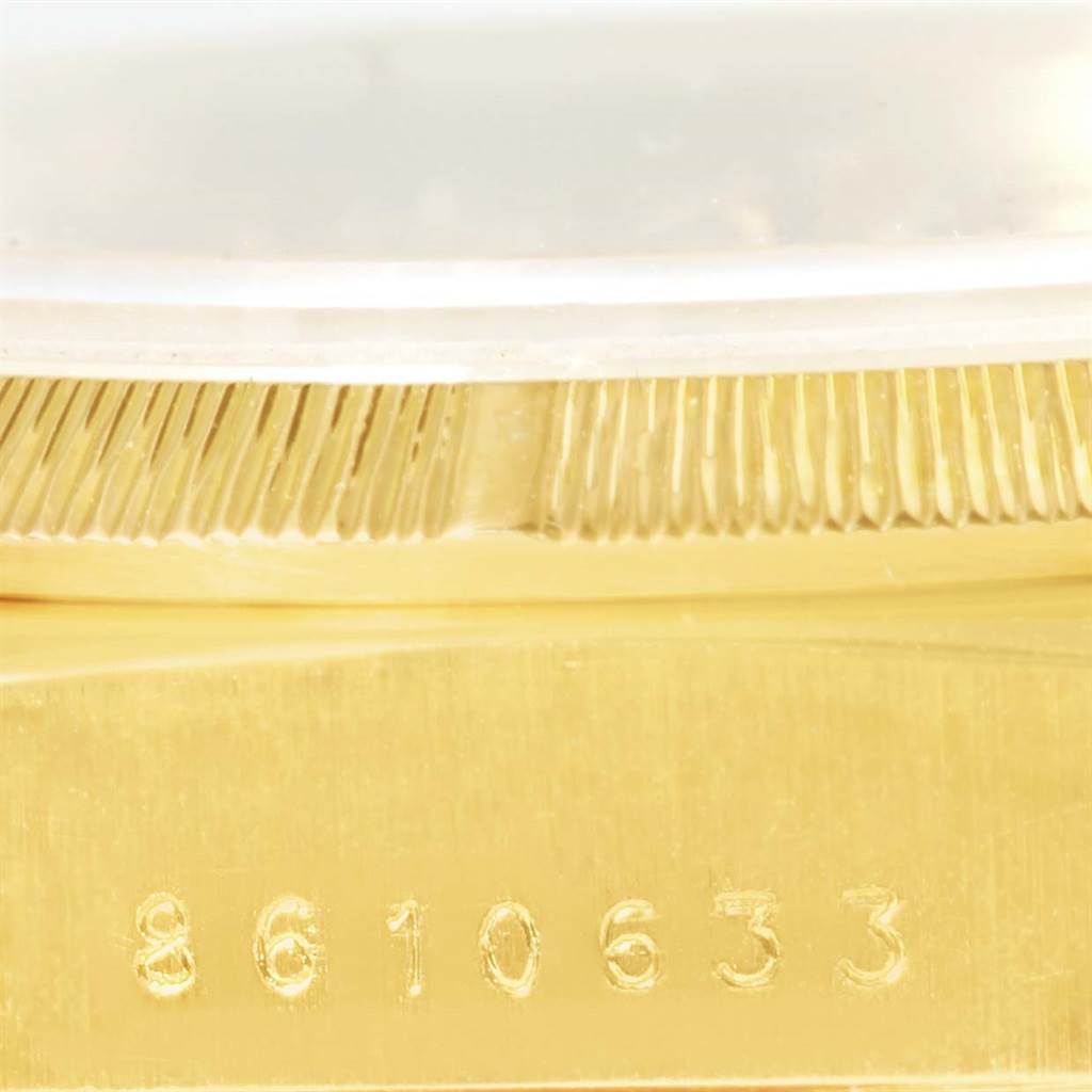 This close-up shows the serial number and a portion of the bezel of a Rolex President 18078 Men
s Yellow Gold Champagne Dial 18078 Men
s Yellow Gold Champagne Dial model watch.
